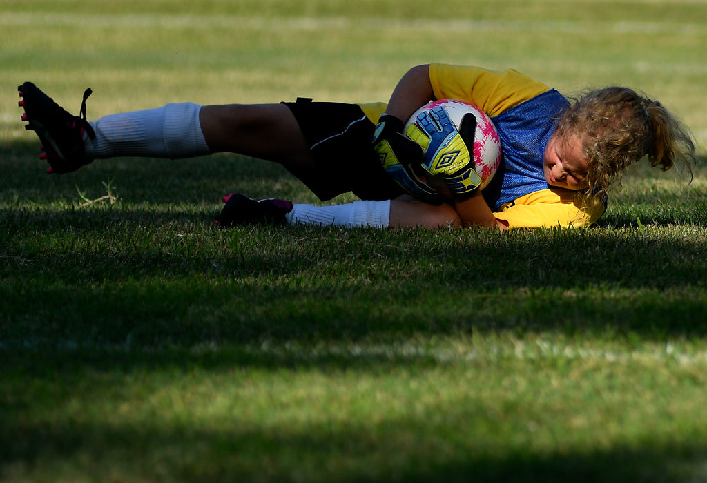 Anna McCrary, 9, saves a shot from the Hannibal Honey Raiders